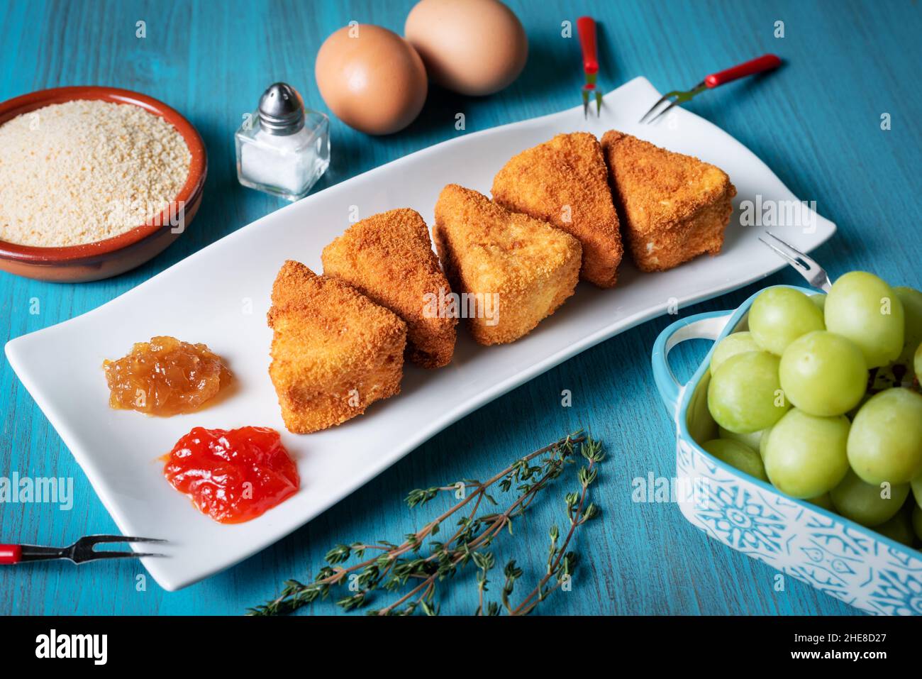 Fried Camembert cheese in portions with breadcrumbs, eggs,marmalade and