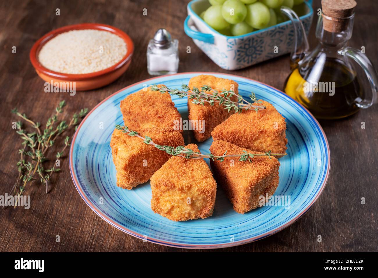 Fried camembert cheese in portions with breadcrumbs, salt, oil and