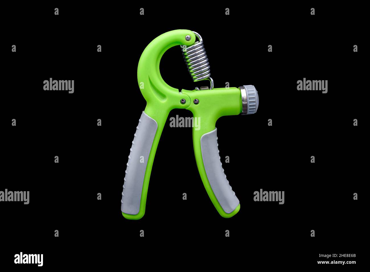 Green Hand Grip Strengthening Tool isolated on black background. Stock Photo