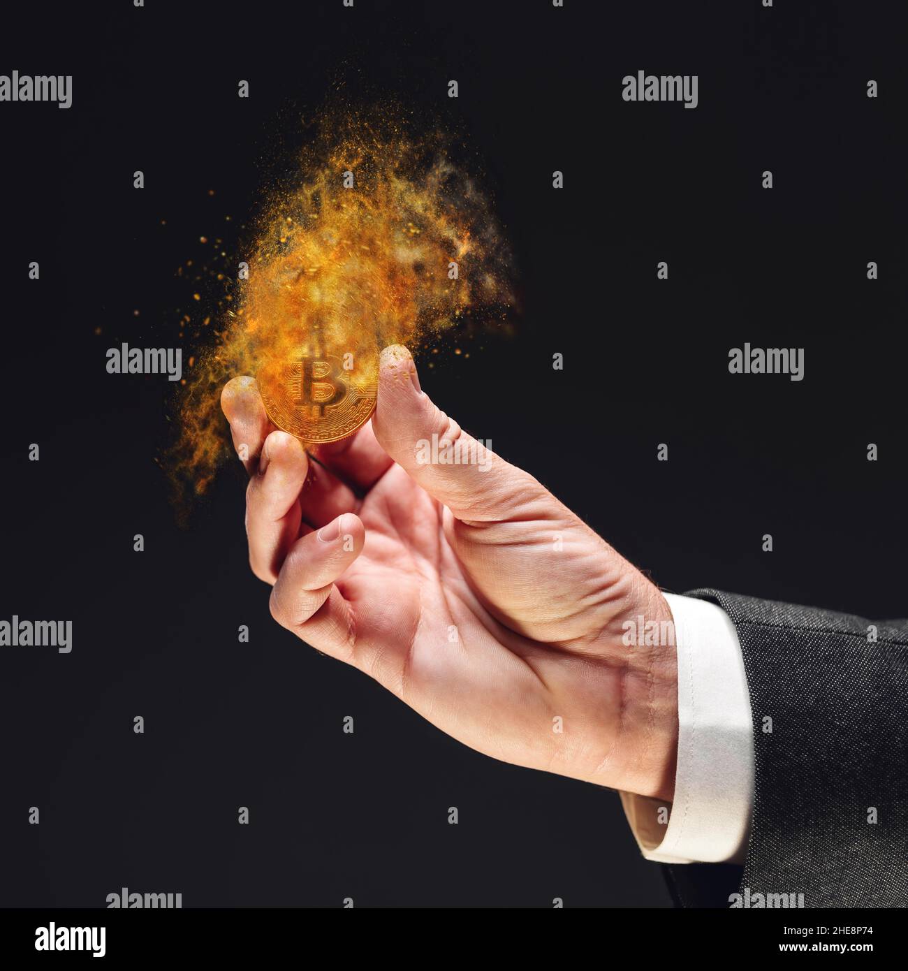 Bitcoin cryptocurrency loosing value, investor holding crypto currency dissolving coin in hand, conceptual image with selective focus Stock Photo