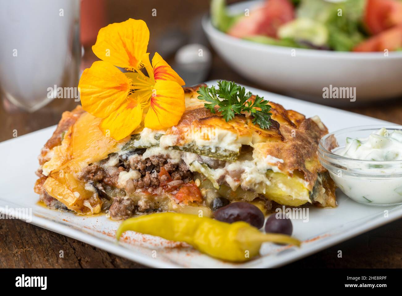 Griechisches moussaka auf weissem teller hi-res stock photography and ...
