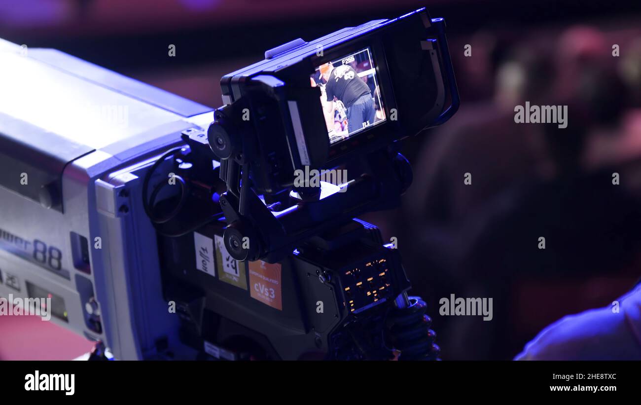 tv camera in a concert hal. Professional digital video camera. TV broadcast of the event from the concert hall. Covering an event with a video camera. Stock Photo