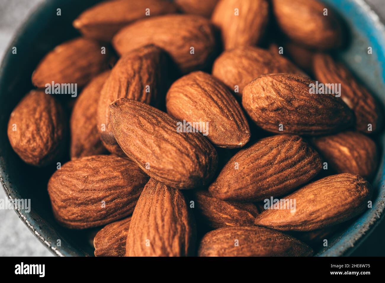 Almond Nuts in plate macro shot with selective focus. Healthy organic nutrition eating. Stock Photo