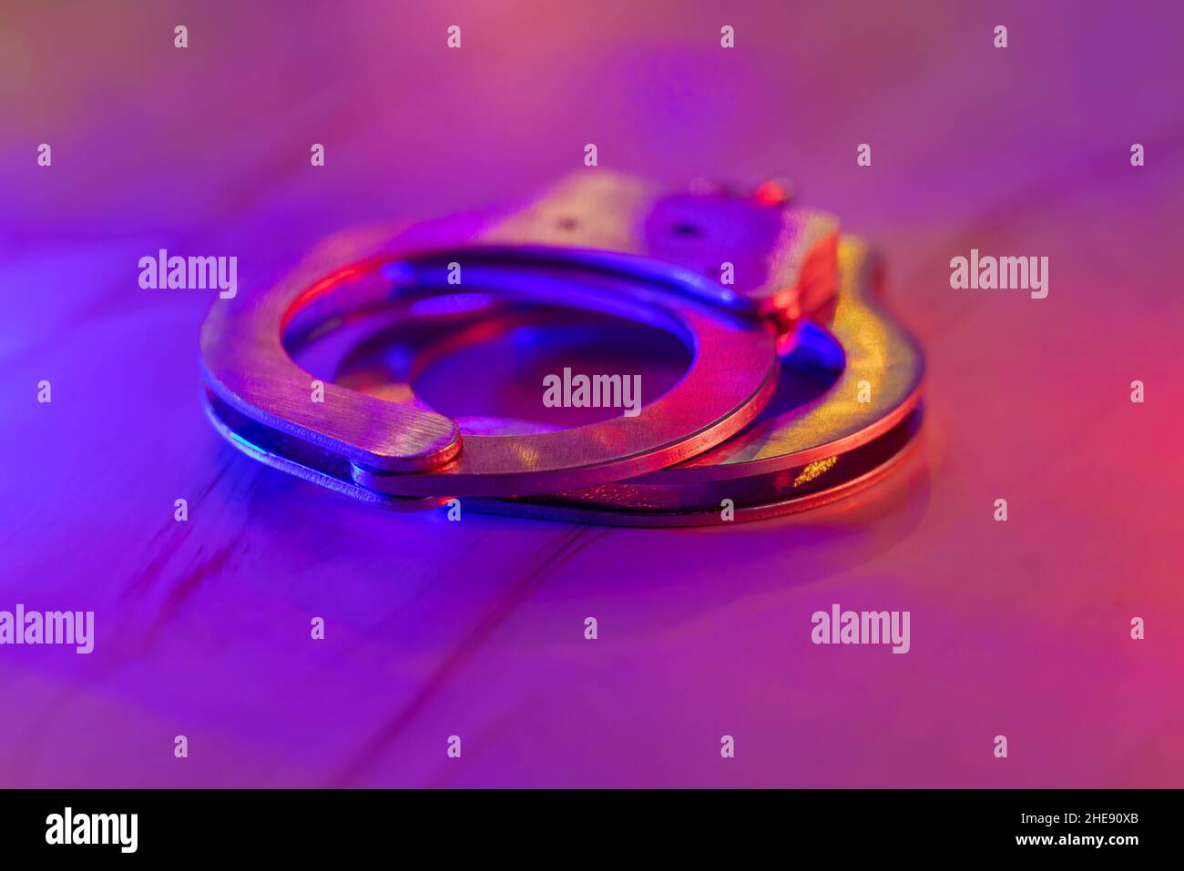 Legal law of handcuffs with the flashing red and blue police lights