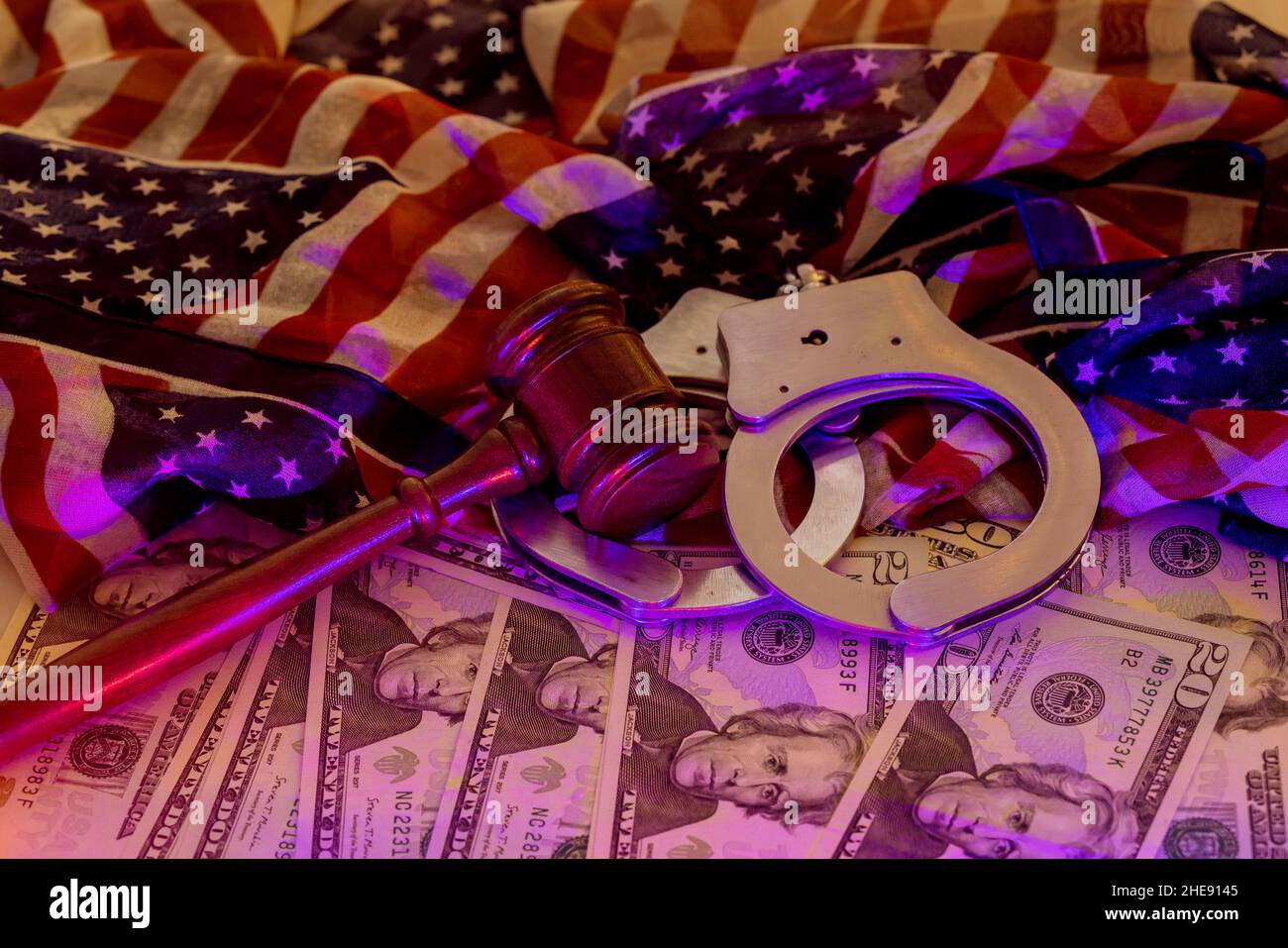 Financial coruption legal justice the wooden judgment gavel police handcuffs of cash US dollars with light flasher police Stock Photo