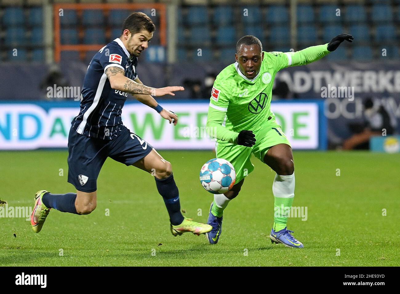 Bochum, Germany. 9th Jan, 2022. Jerome Roussillon (R) of Wolfsburg vies with Christian Gamboa of Bochum during their German first division Bundesliga football match in Bochum, Germany, Jan. 9, 2022. Credit: Ulrich Hufnagel/Xinhua/Alamy Live News Stock Photo