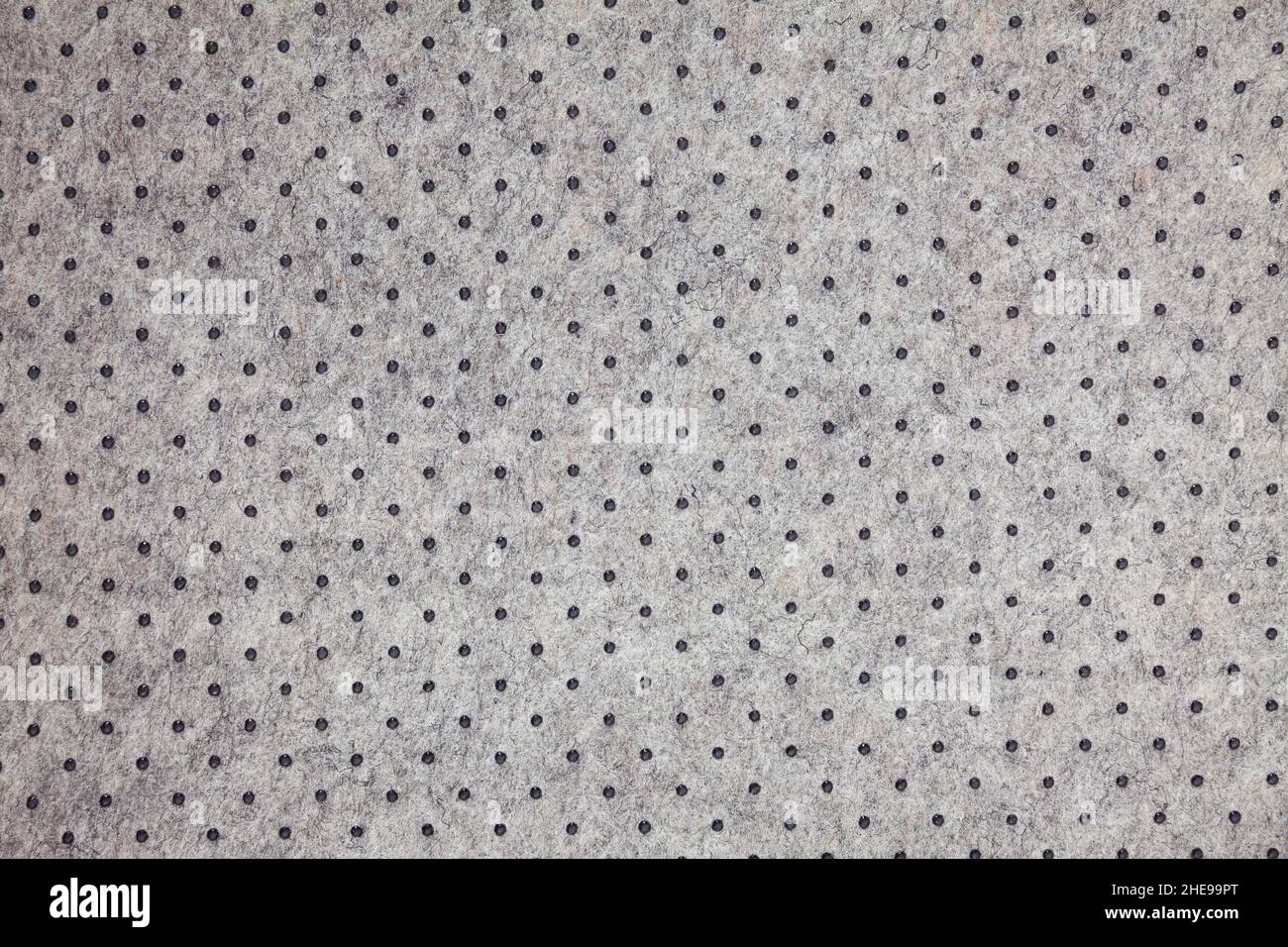 Grey felt material background with dark dots Stock Photo