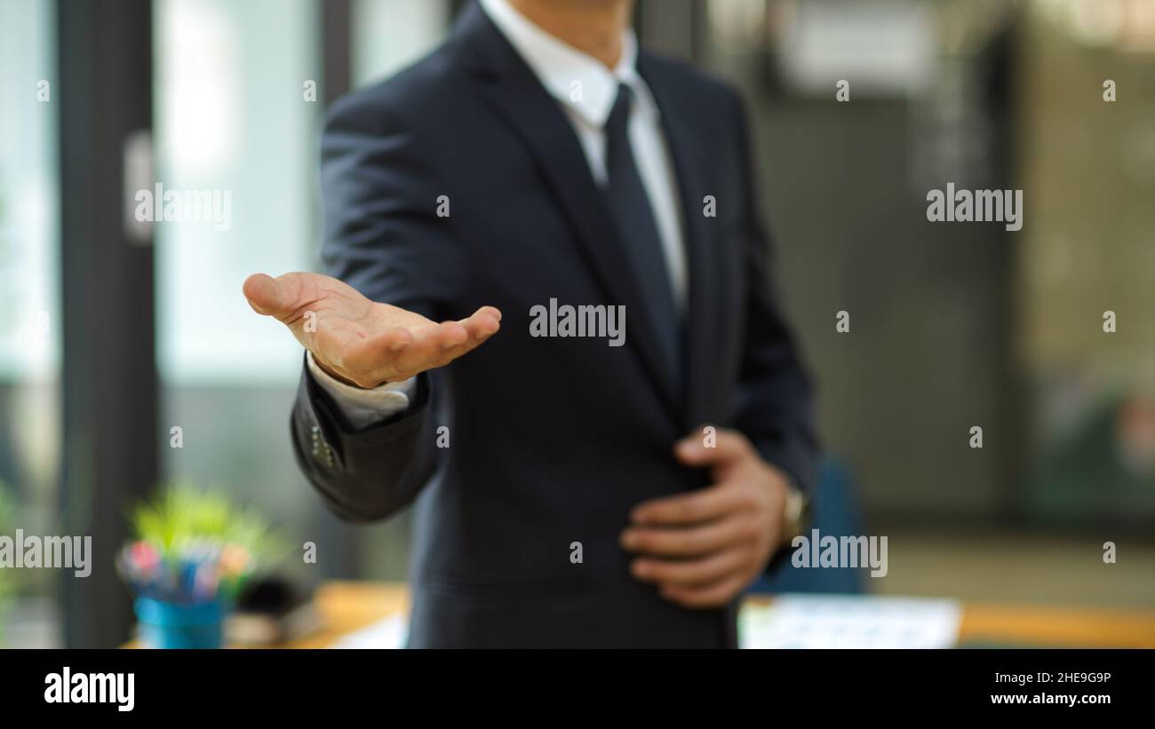 Businessman stretch hand for handshake greeting his partners in the ...