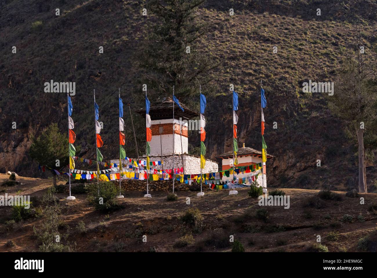 Chorten and prayer flags in the mountain, Paro, Bhutan Stock Photo