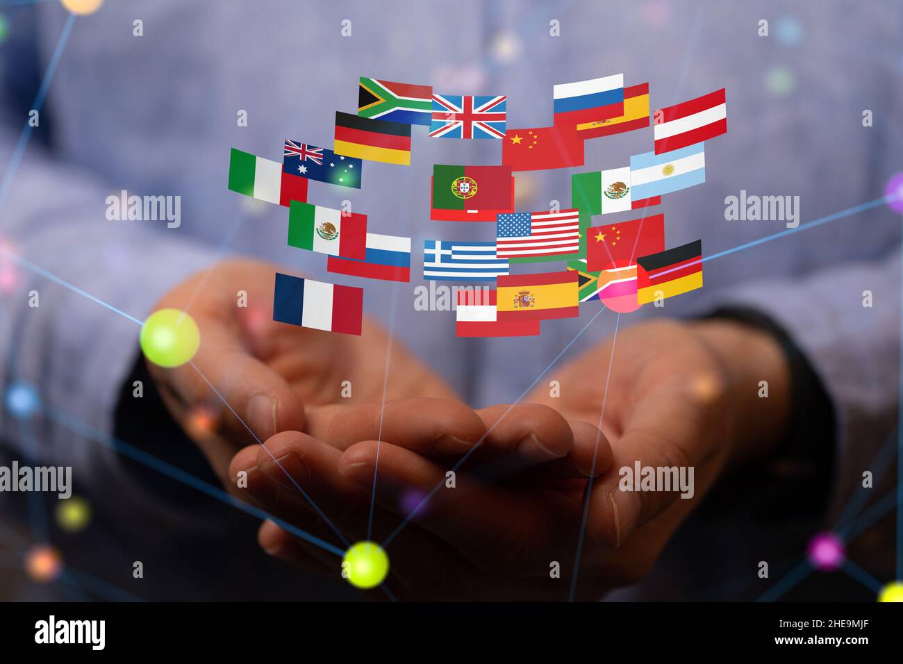 Shallow focus of human hands holding the flags of various countries, globalization concept Stock Photo