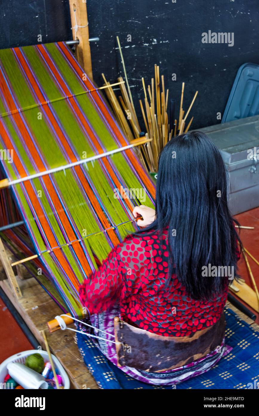 Woman weaving by loom, Thimphu, Bhutan Stock Photo
