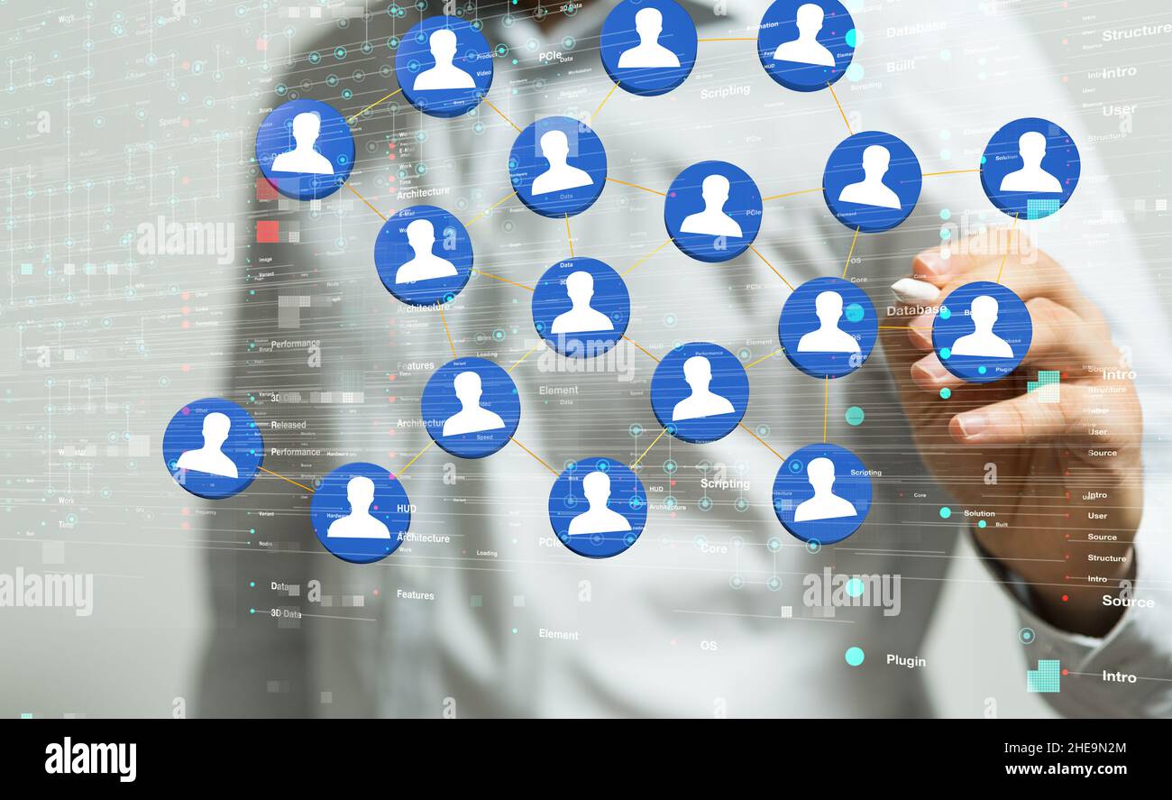 Shallow focus of a human hand with a pen, pointing on small icons, team networking concept Stock Photo