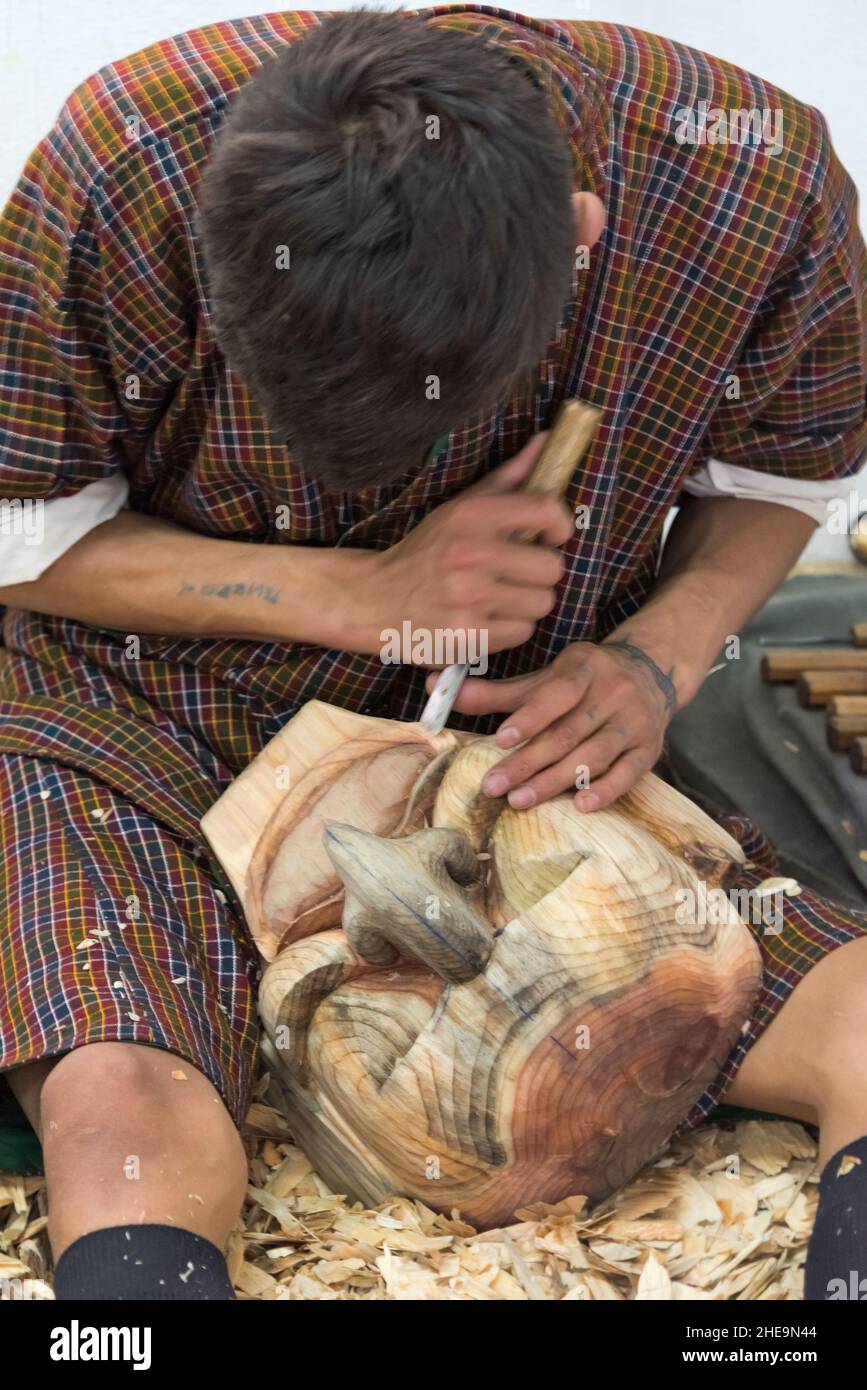 Student carving wood mask in a technical vocational school, Thimphu, Bhutan Stock Photo
