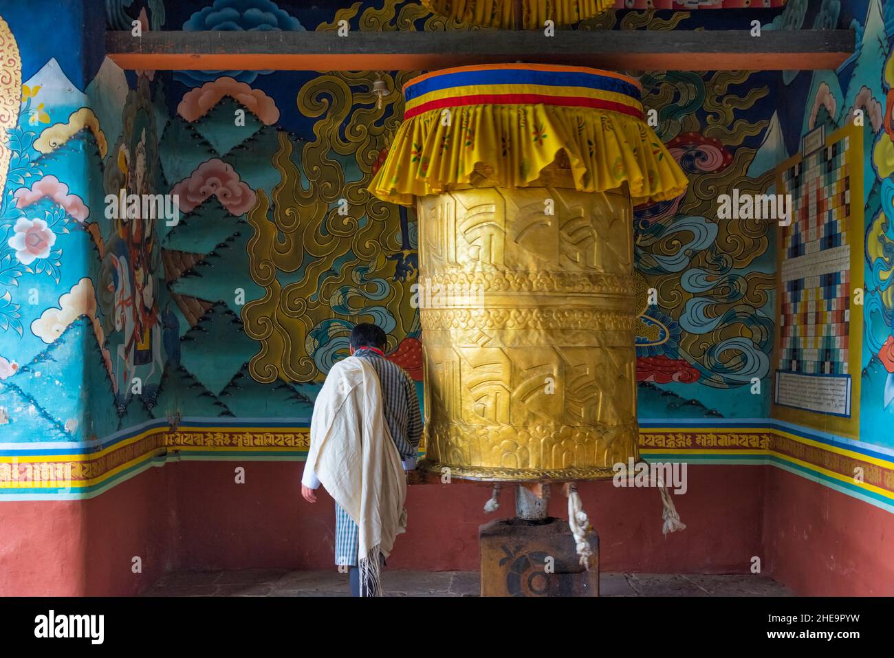 Pilgrim spinning prayer wheel in Punakha Dzong, Punakha, Bhutan Stock Photo