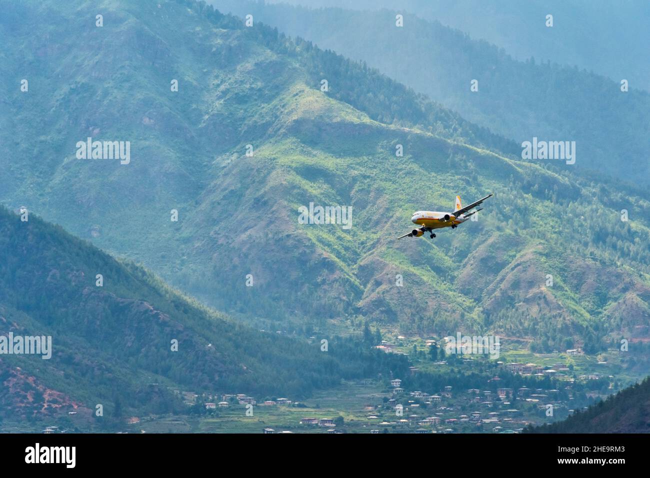 Airplane flying in the Paro Valley, Paro, Bhutan Stock Photo