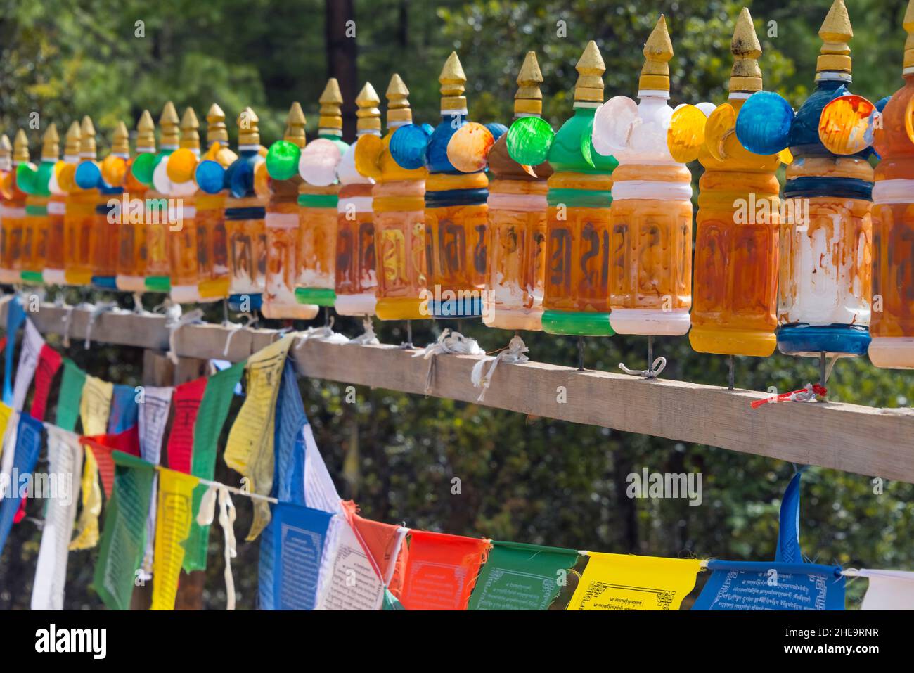 Prayer wheels and prayer flags in the precincts of Paro Taktsang (also known as Tiger's Nest), Paro, Bhutan Stock Photo