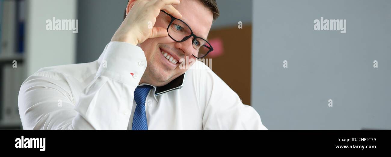 Happy professional employee in cabinet Stock Photo