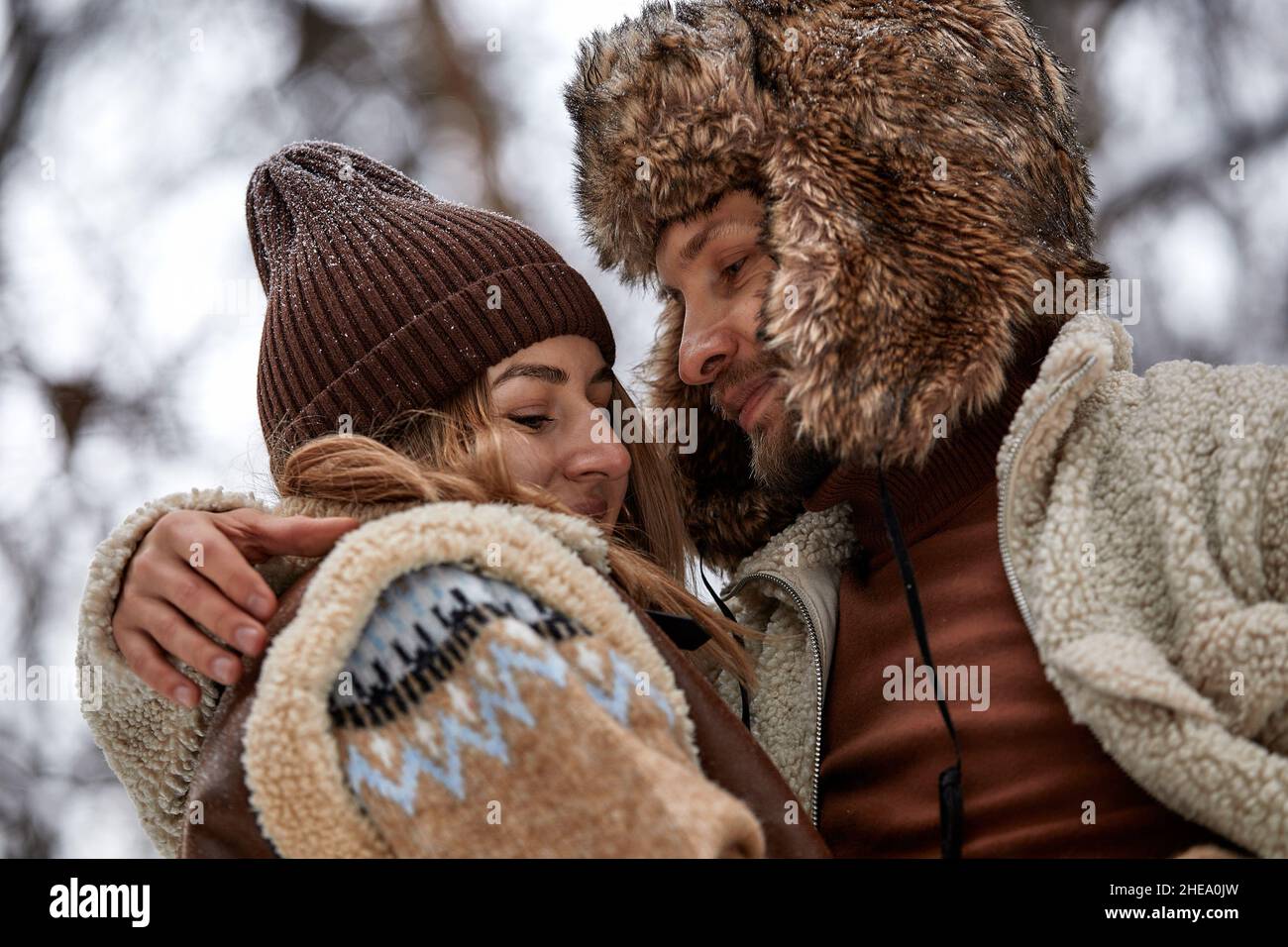 Young couple hugging and kissing in the Park in winter Stock Photo - Alamy