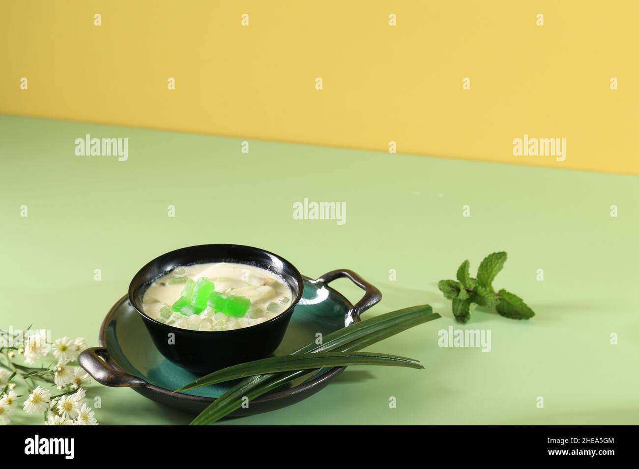 Buko Pandan is a Drink Originally from Philippines, Made from  Jelly, Young Coconut, Evaporated Milk, Sweetened Condensed Milk, Served on Black Bowl, Stock Photo