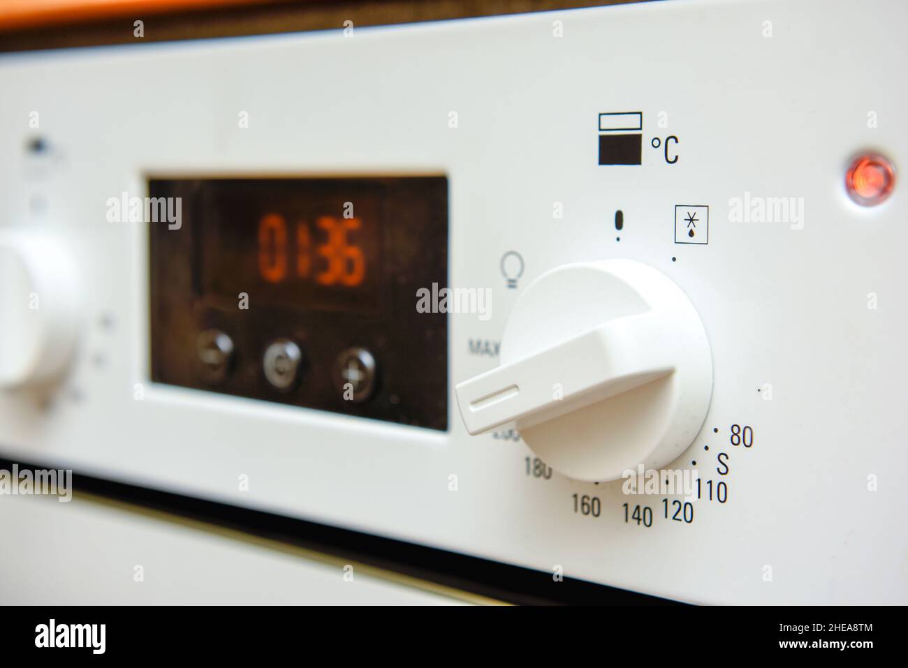 Electric oven dial close up on the switch of the cooker turned up hot Stock Photo Alamy