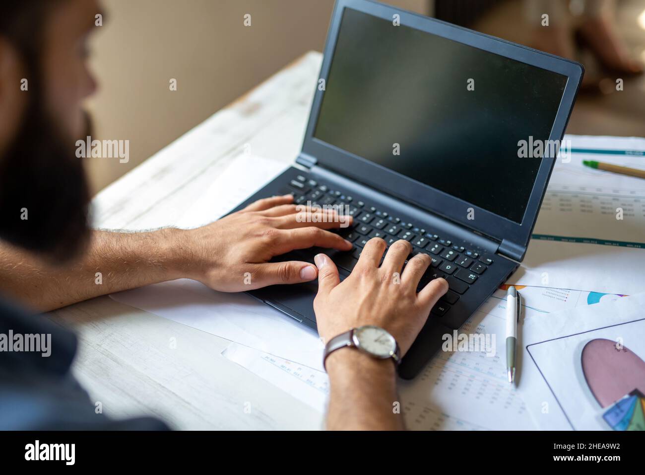 Successful businessman working in the office analyzing business data on notebook Stock Photo