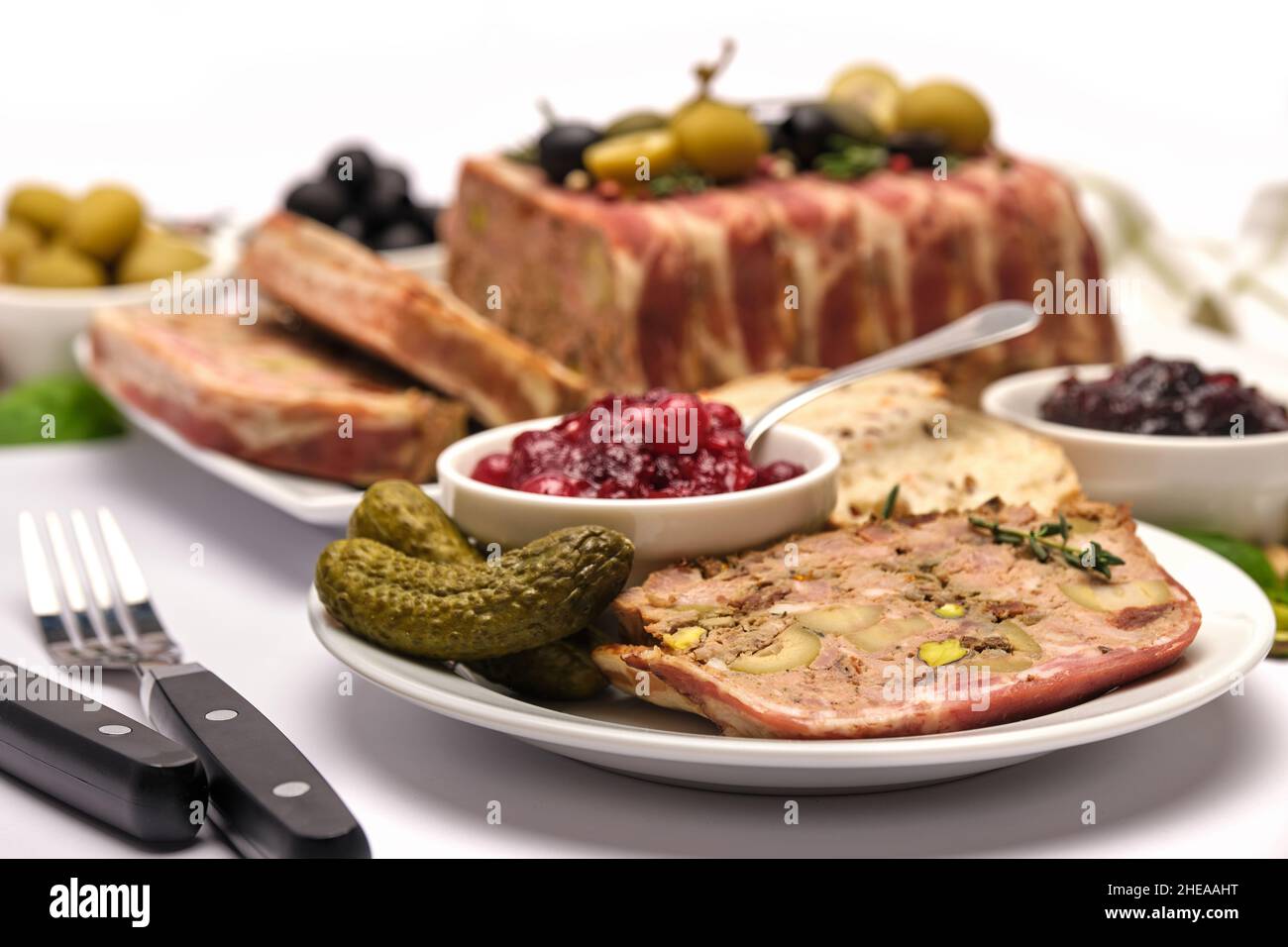 Traditional French terrine covered with bacon isolated on white