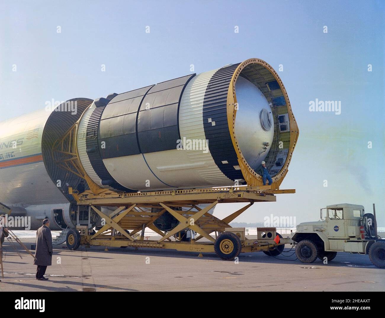 This photograph was taken at the Redstone airfield, Huntsville, Alabama, during the unloading of the Saturn V S-IVB stage that housed the Orbital Workshop (OWS) from the Super Guppy, the NASA plane that was specially built to carry oversized cargo. The OWS measured 22 feet (6.7 m) in diameter, and 48 feet (14.6 m) in length. The Saturn V S-IVB stage was modified at the McDornell Douglas facility at Huntington Beach, California, for a new role, which was to house the OWS. In addition to the test articles, engineering mockups, and flight equipment, both McDonnell Douglas and Martin Marietta buil Stock Photo