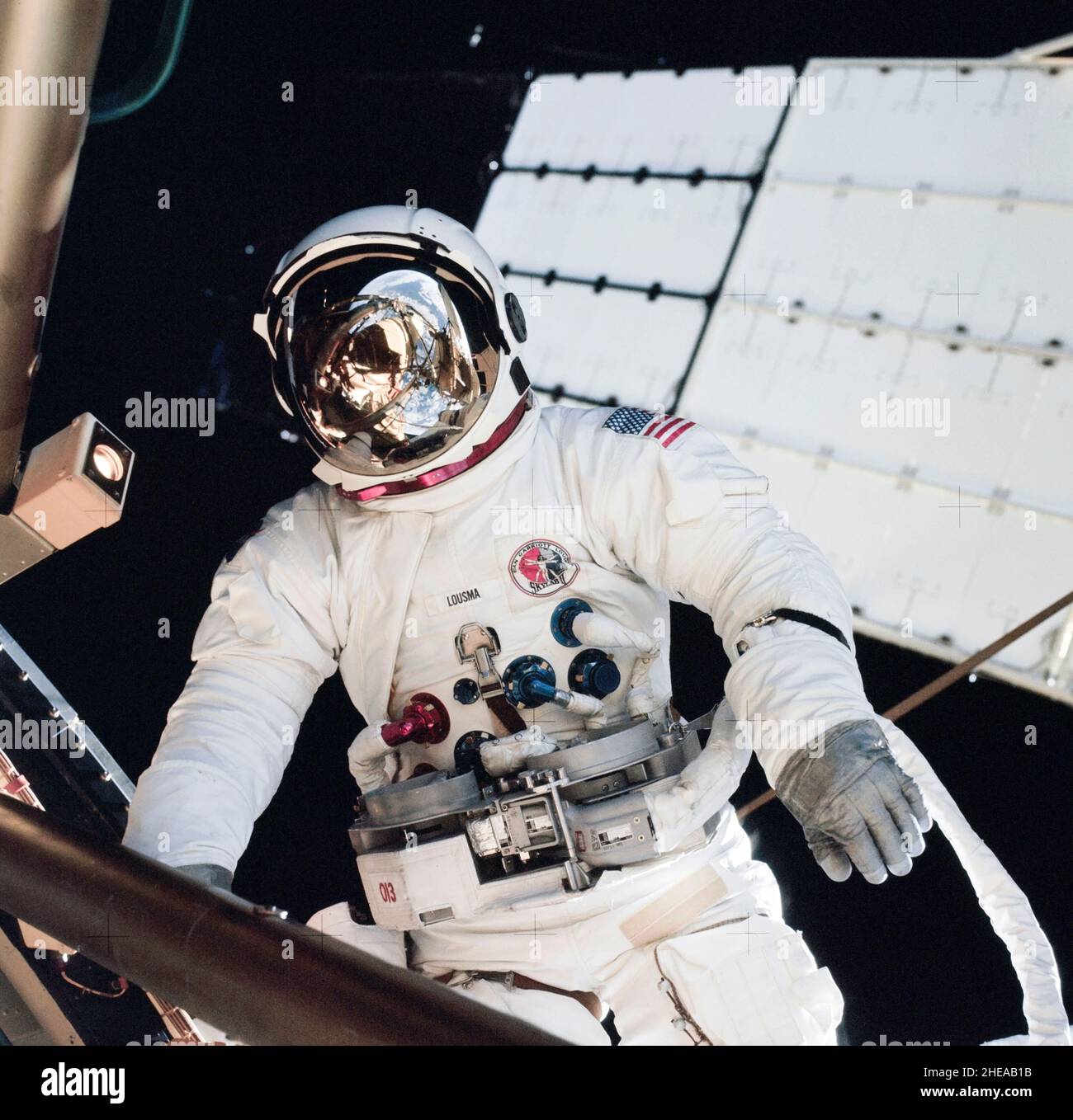 (6 Aug. 1973) --- Astronaut Jack R. Lousma, Skylab 3 pilot, participates in the Aug. 6, 1973, extravehicular activity (EVA) during which he and astronaut Owen K. Garriott, science pilot, deployed the twin pole solar shield to help shade the Orbital Workshop (OWS). Note the striking reflection of the Earth in Lousma?s helmet visor. This photograph was taken with a 70mm hand-held Hasselblad camera Stock Photo
