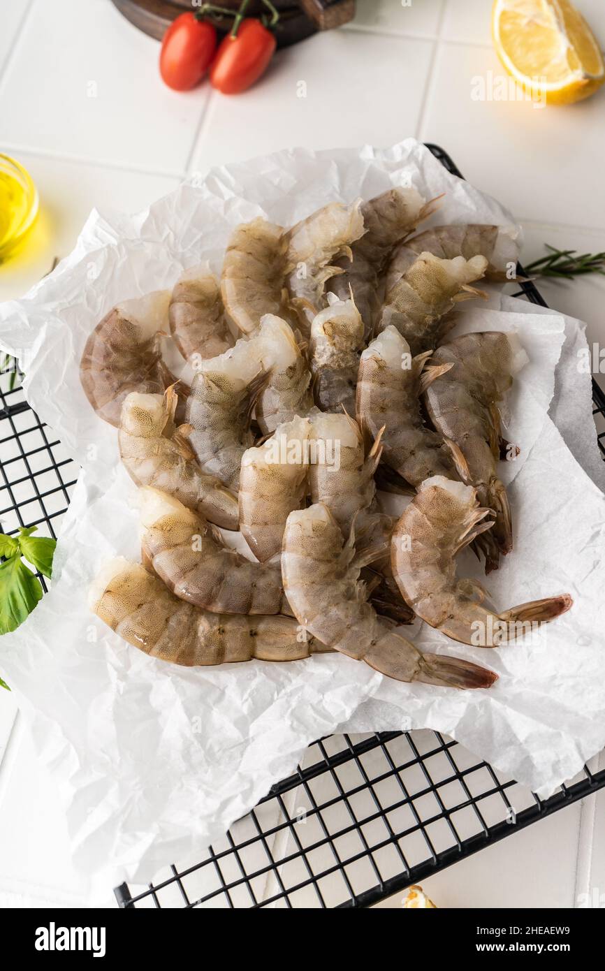 Thawed peeled shrimp, seafood, delicacy. on a white background, in a ...
