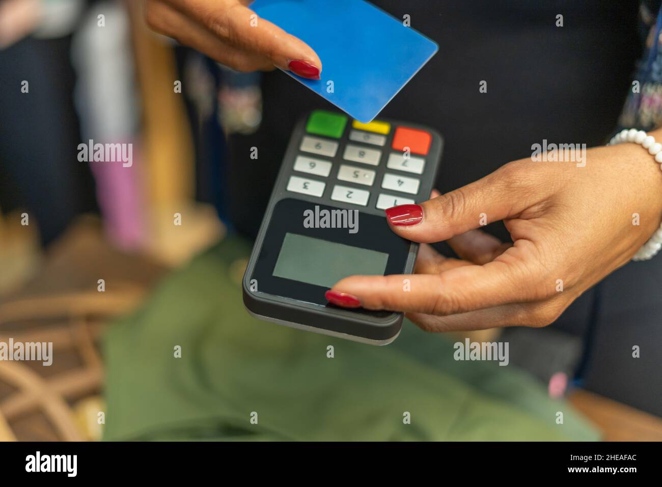 Credit card payment cashless contactless concept.Woman holding machine for customer in shop payment Stock Photo