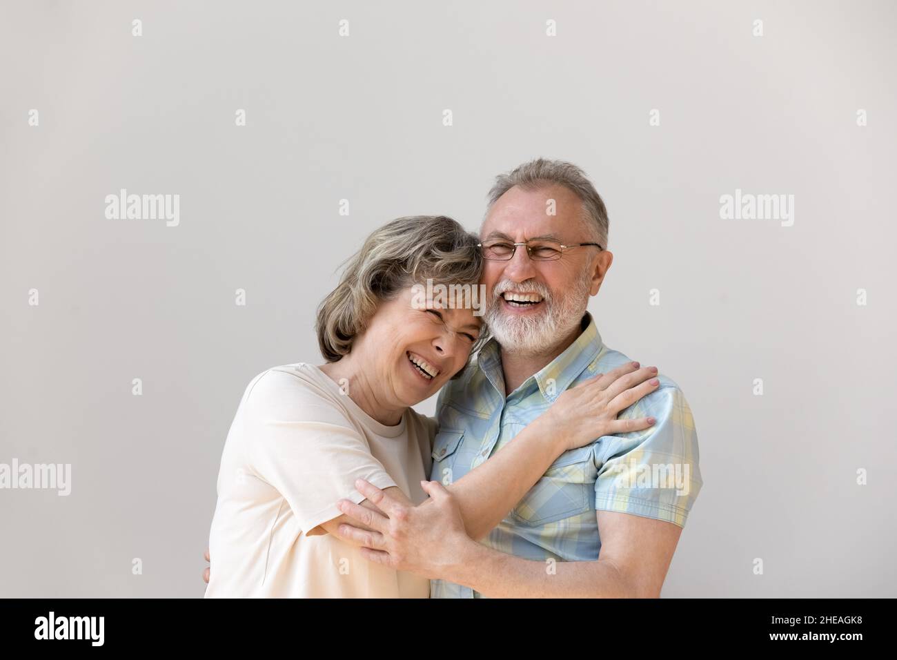 Sincere laughing bonding middle aged couple feeling happy. Stock Photo