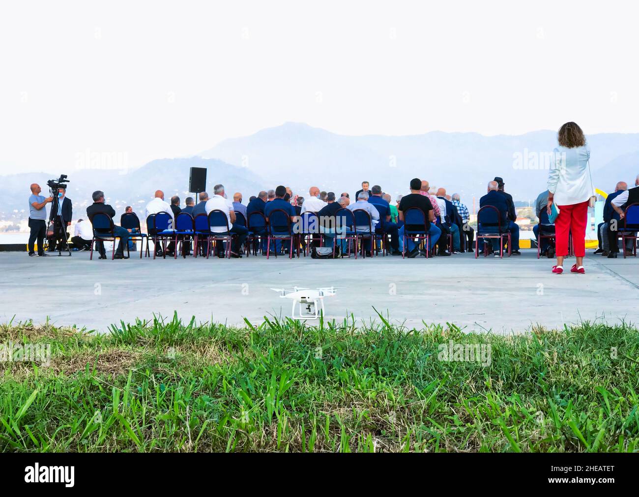 17th of october, Batumi, Georgia. Group of people sitting on the chairs outside in public event with a drone standing in the foreground. Political agi Stock Photo