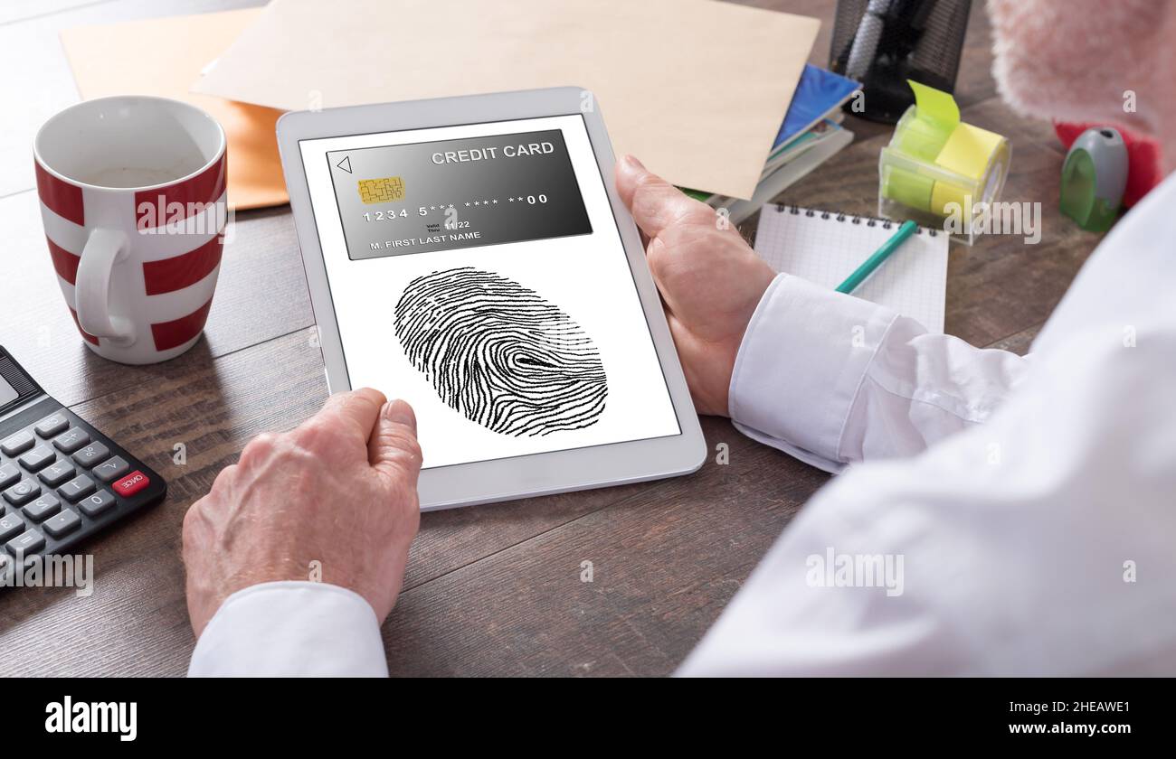 Payment security concept shown on a tablet held by a man Stock Photo