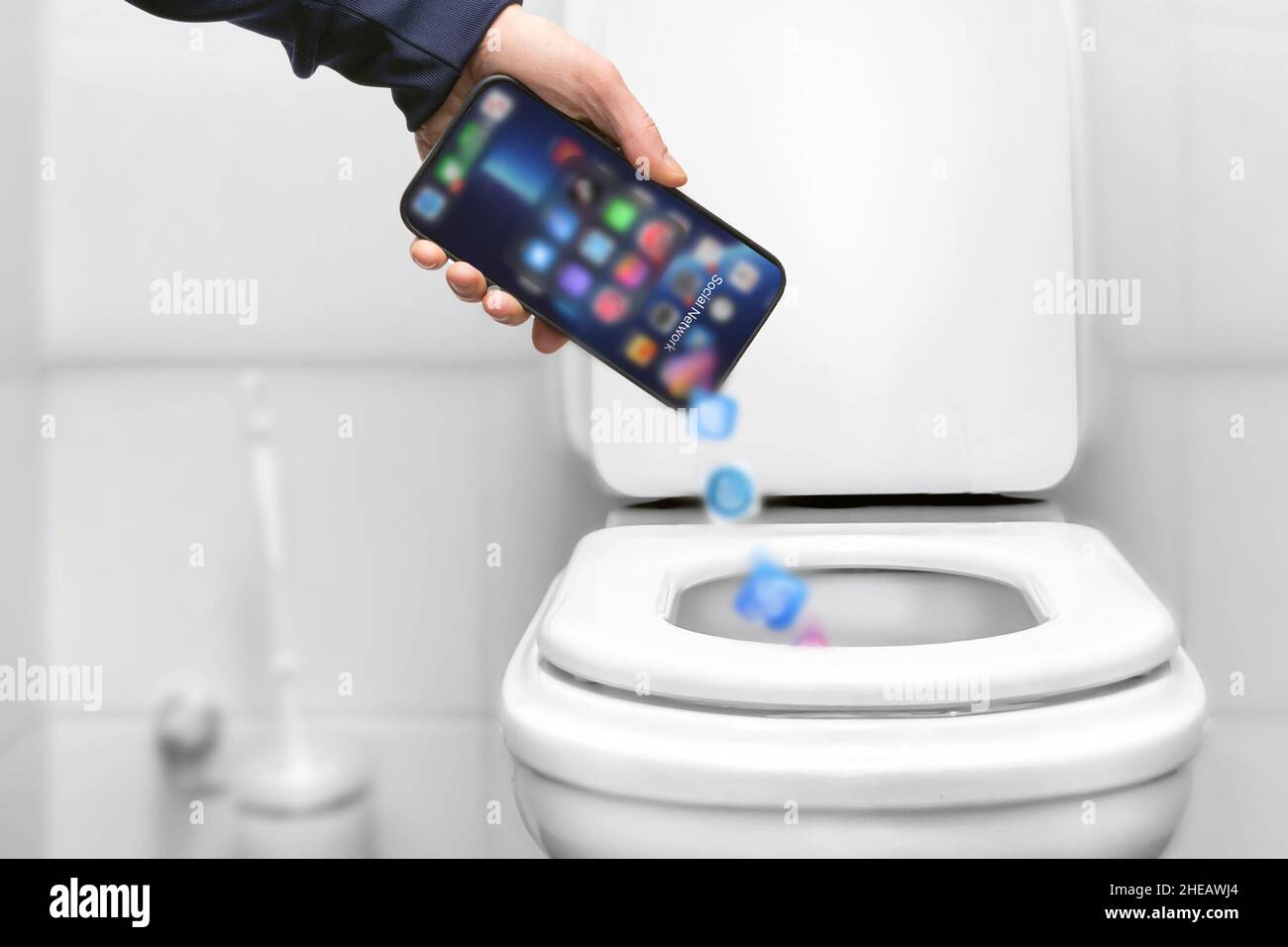 dependence on social networks and a smartphone, throws the phone into the  trash toilet bowl hand, liberation from slave dependence online. deleting  ap Stock Photo - Alamy