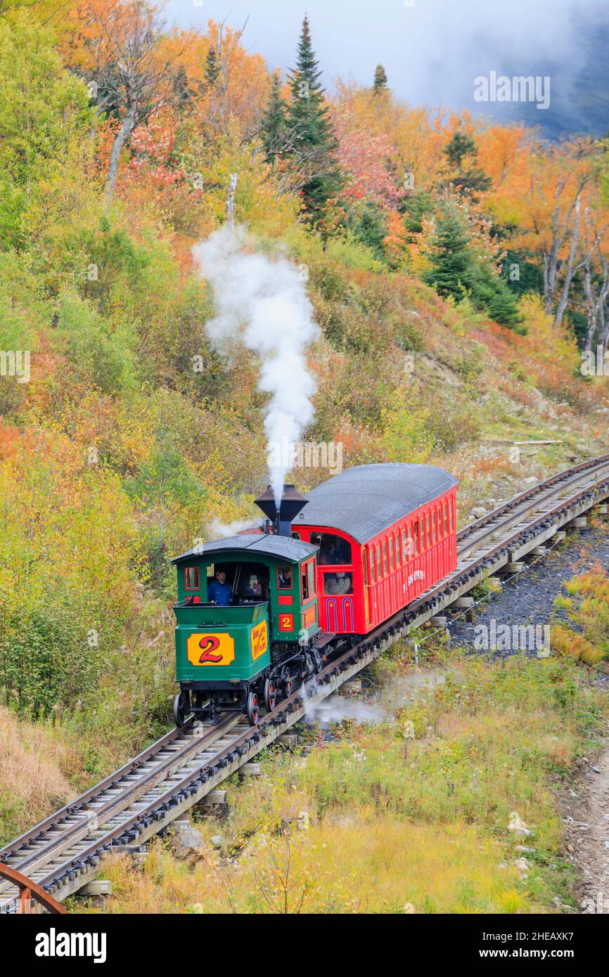 Vintage steam train with smoke climbing the Mount Washington Cog Railway, Mount Washington, New Hampshire, New England, USA Stock Photo