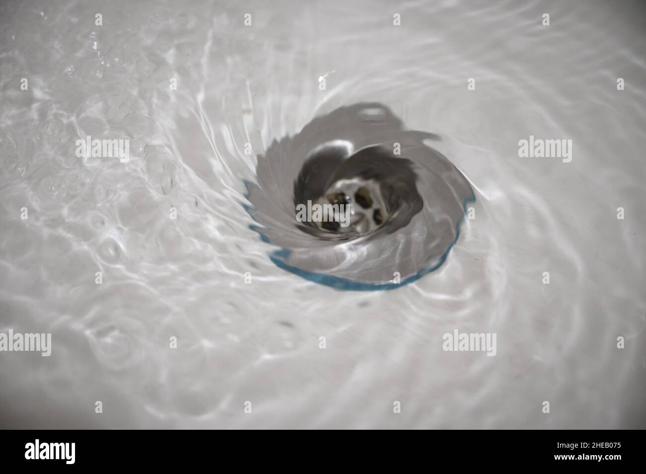 Water flowing down the hole in a kitchen sink Stock Photo - Alamy