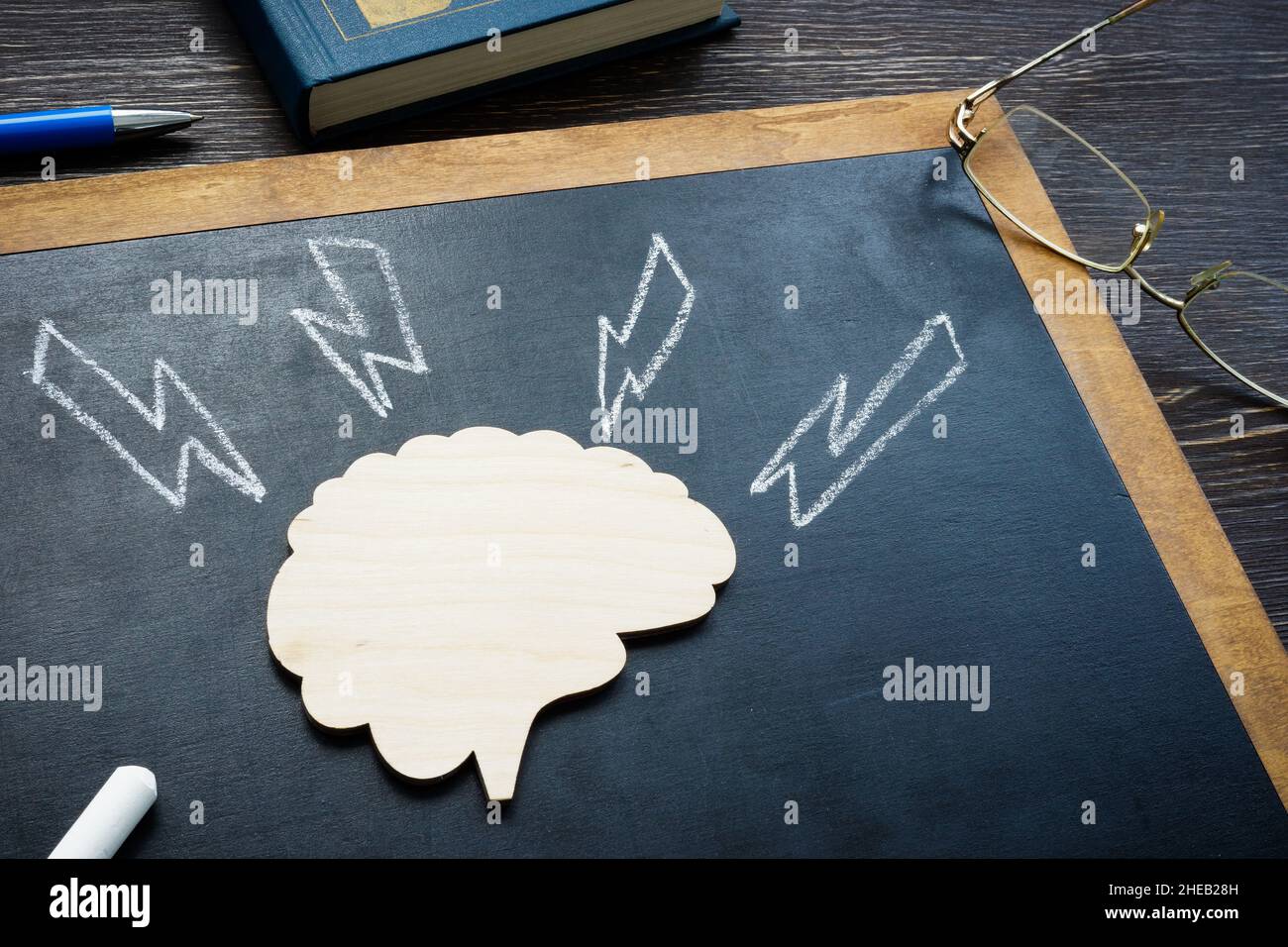 Model of brain and arrows as stroke or emotional pressure. Stock Photo