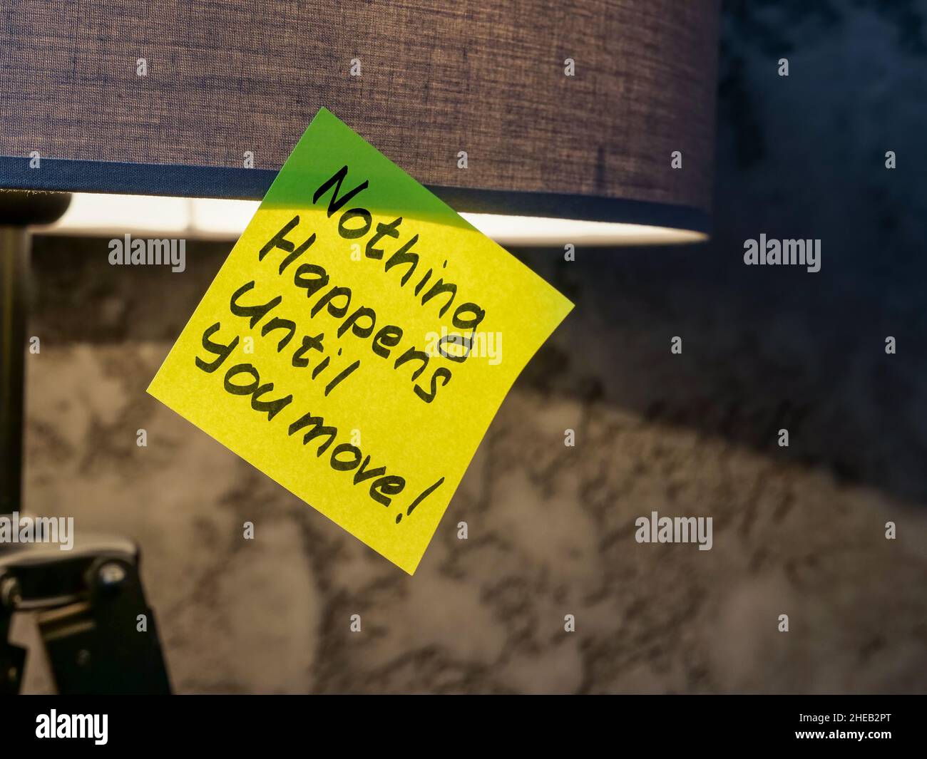 Sticker with the inscription Nothing happens until you move on the floor lamp. Stock Photo