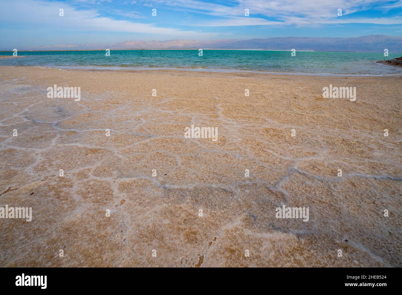 water level receding and salt crystallization due to evaporation on the shores of the Dead Sea, Israel Stock Photo