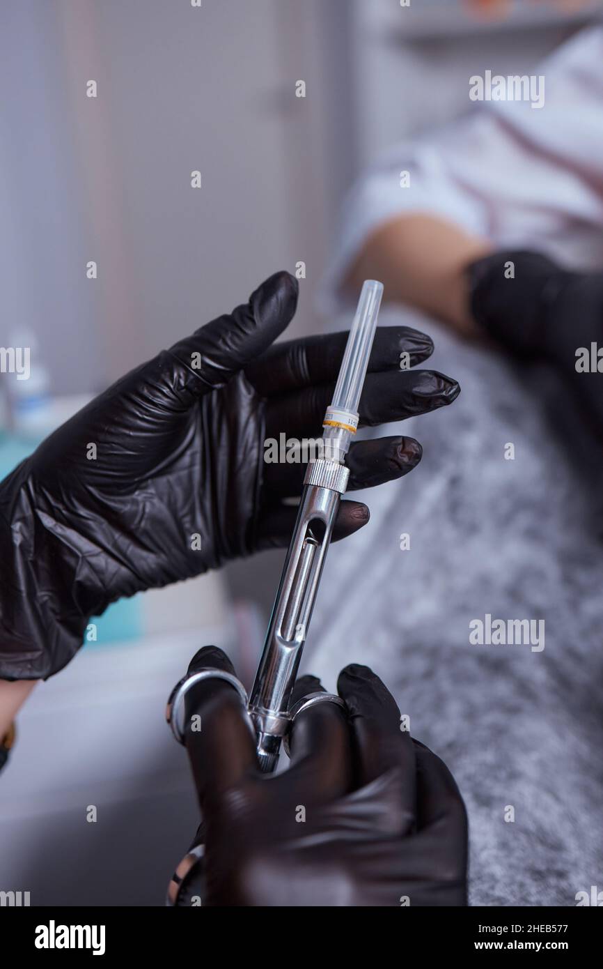 Little girl at dentist office, getting local anesthesia injection into