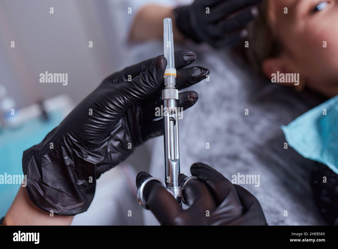 Little girl at dentist office, getting local anesthesia injection into