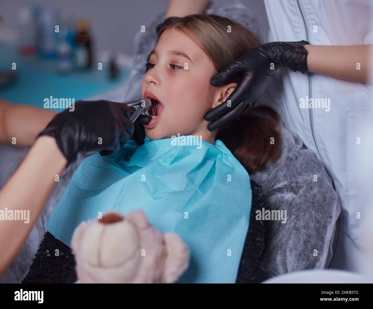 Dentist use anesthetic injection for tooth extraction in child Stock