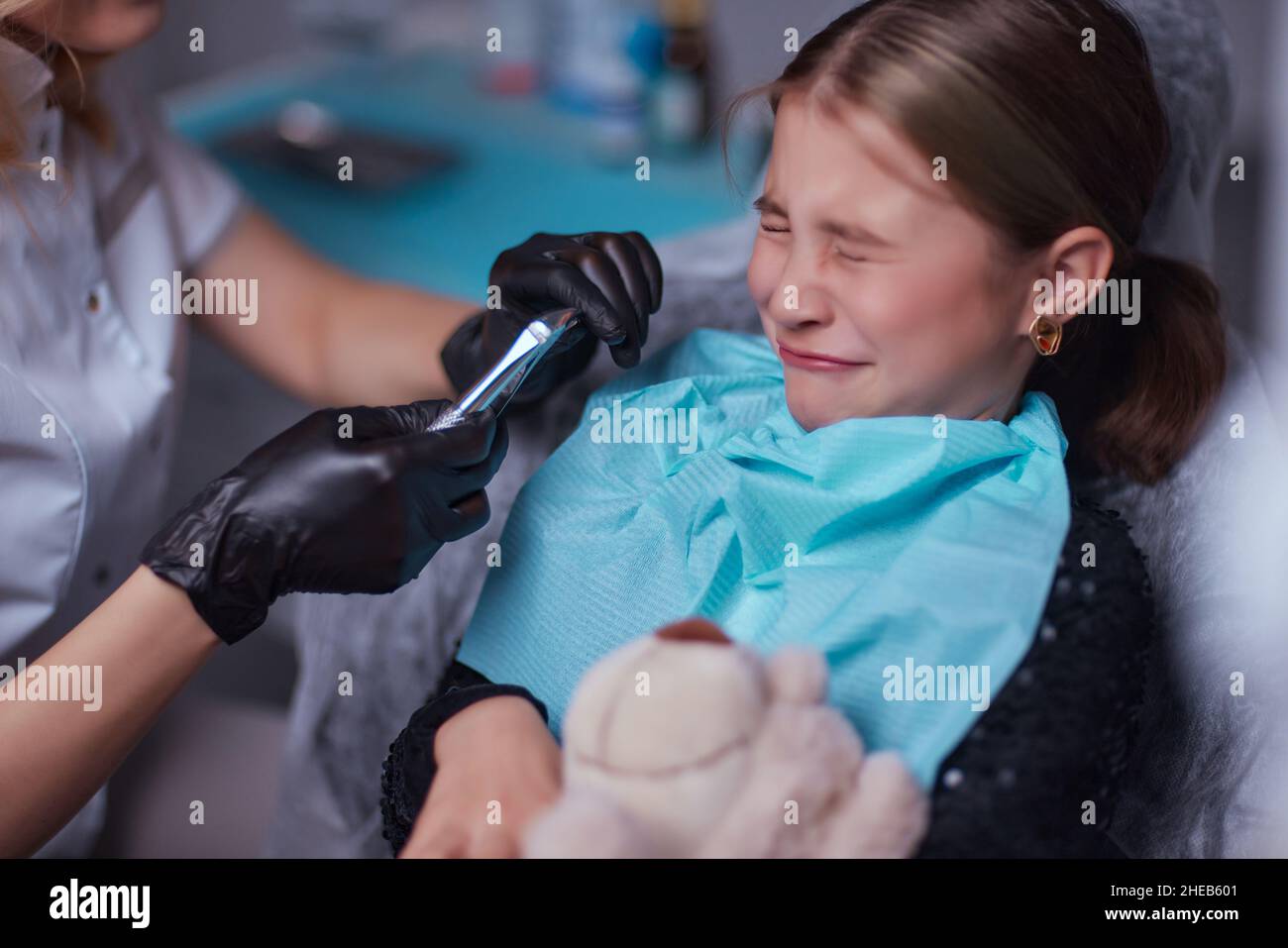 Dentist use anesthetic injection for tooth extraction in child Stock