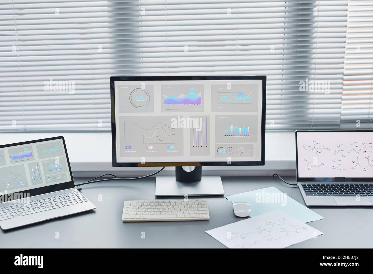 Close-up of computer with big monitor with charts on the screen standing on the table in the lab Stock Photo