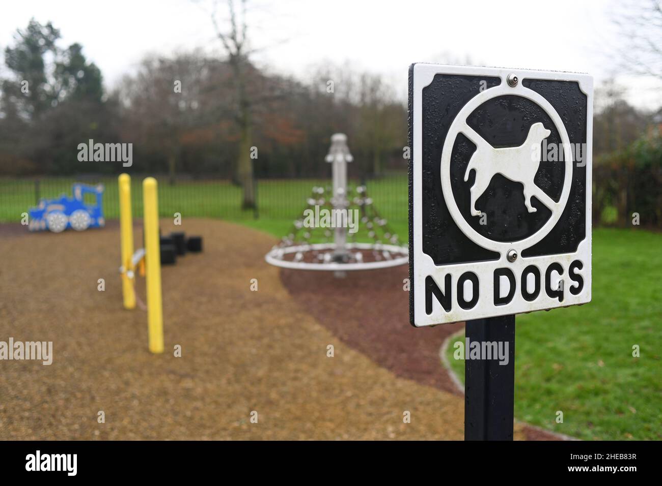 A no dogs allowed sign at a children's playground on a housing estate