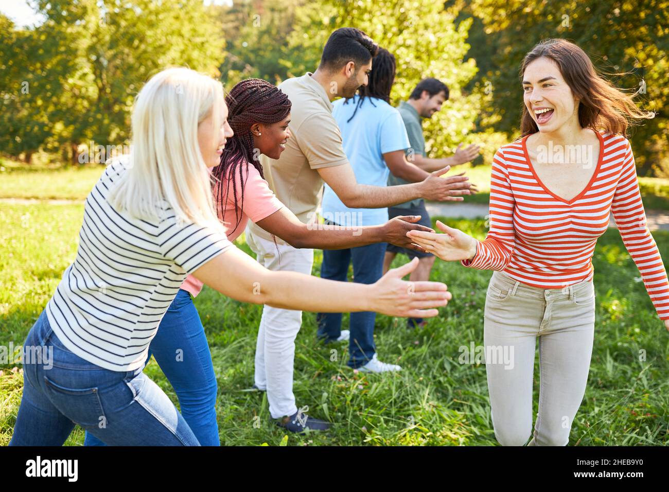 Multicultural startup team clapping in the for team building
