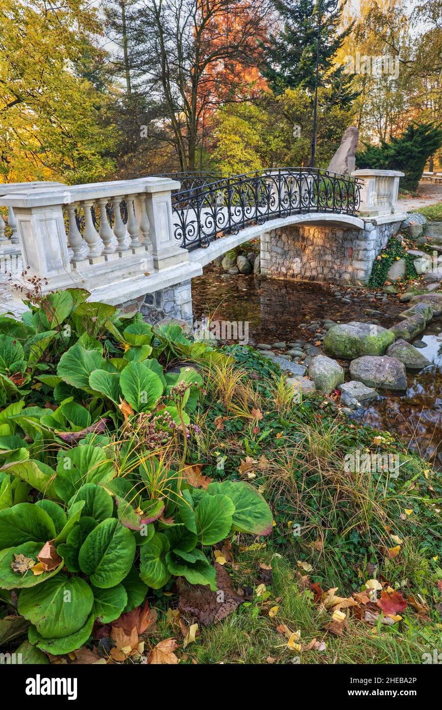 Arch bridge over canal in picturesque scenery of Ujazdowski Park in Warsaw, Poland. Stock Photo