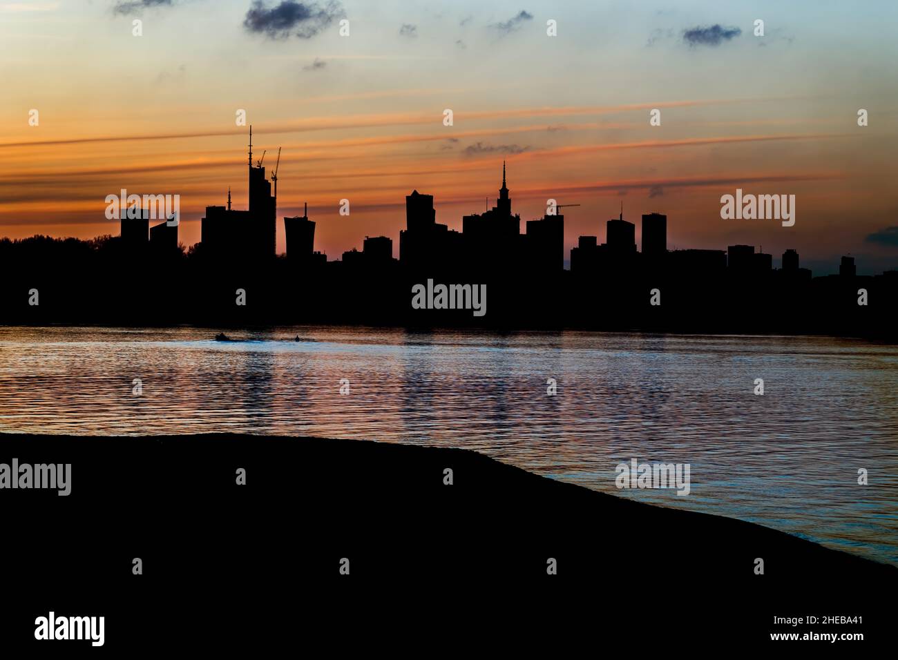 Warsaw city skyline silhouette at twilight, capital of Poland, river ...
