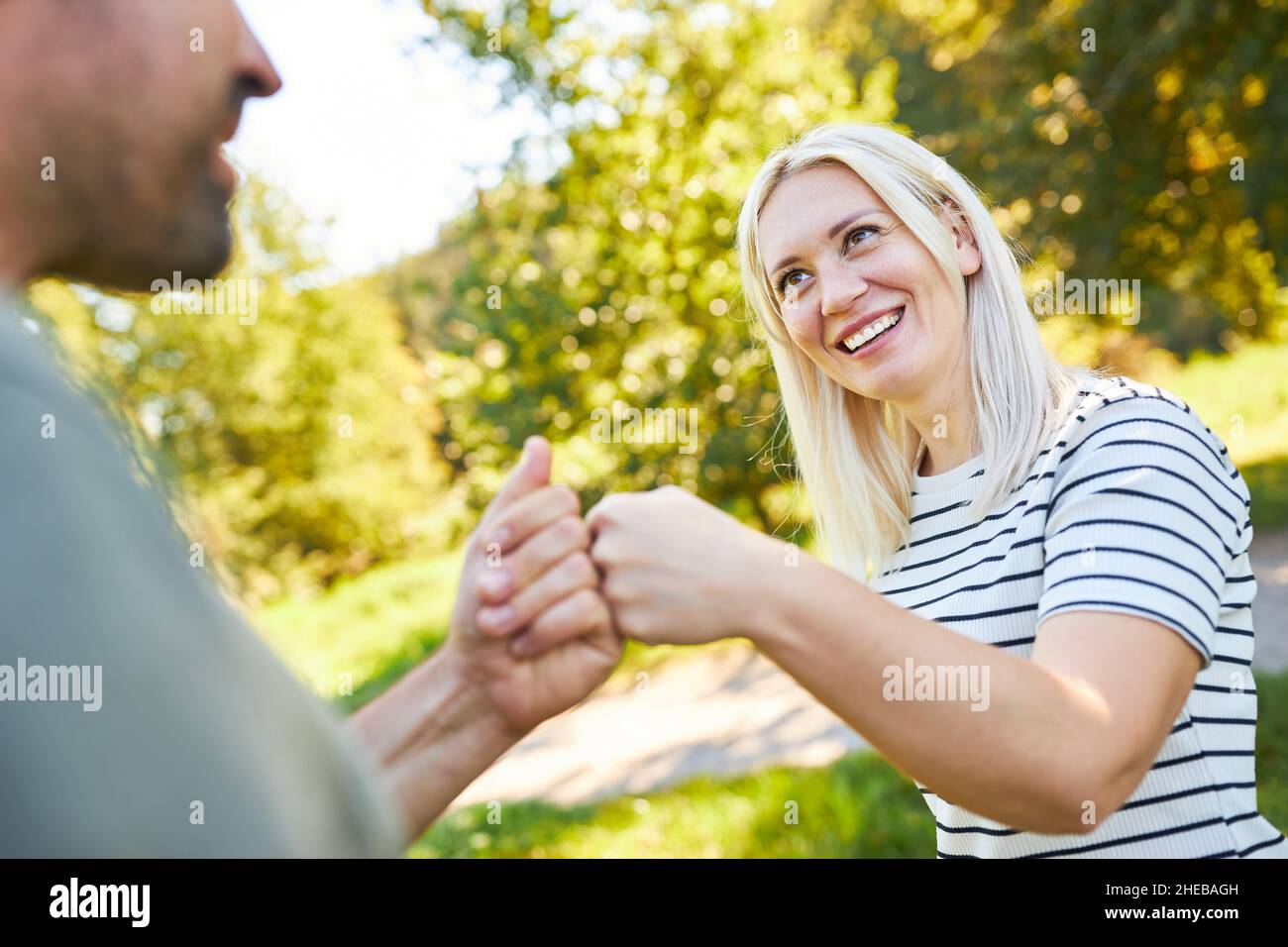 Young people at a greeting with Fist Bump for partnership and cooperation Stock Photo