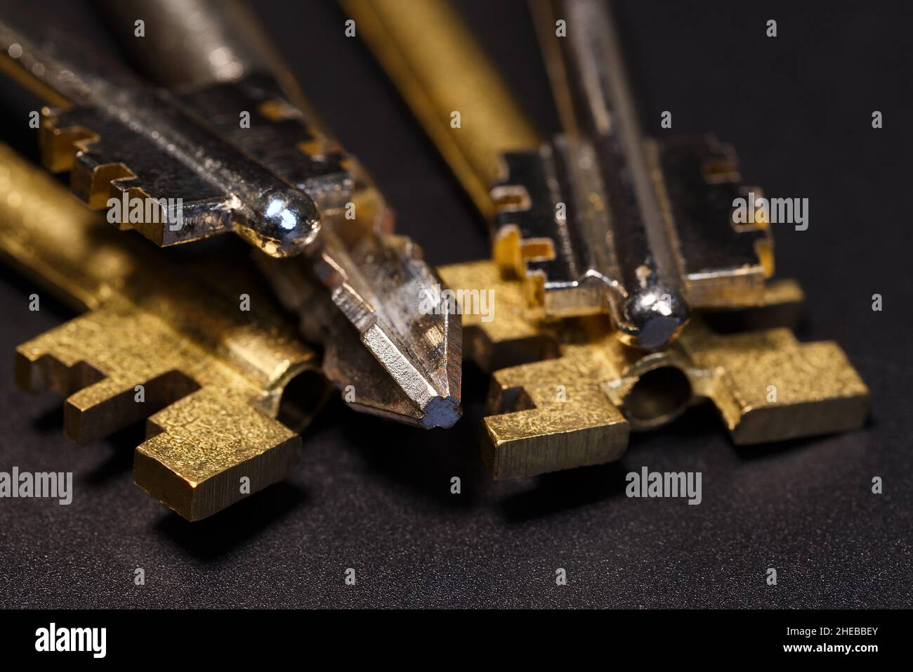 Various types of keys on a dark background. Macro photography Stock Photo